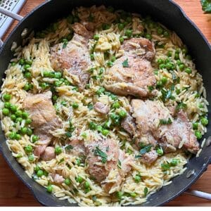 Aerial view of chicken orzo skillet cooked in pan.