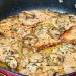 Pork marsala prepared and garnished with parsley in a skillet.