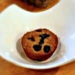 A blueberry muffin sitting inside a white bowl.