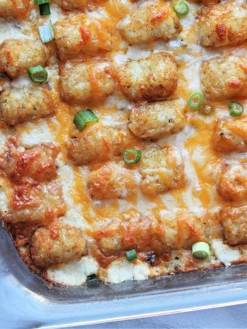 cooked tater tot casserole half of the pan in view