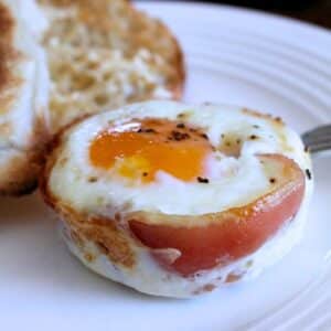 Pancetta egg cup prepared on a white dish.