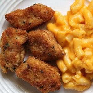 chicken nuggets and macaroni on white plate
