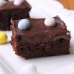 Mini egg brownies on a white serving tray.