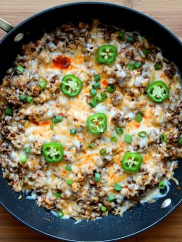 Top view of a black skillet with the prepared taco rice inside.