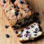 blueberry bread on cutting board with a slice cut