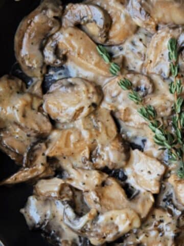 Close up view of prepared creamy mushrooms in skillet.