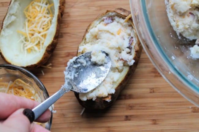 spooning mixture back into potato skin