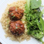 air fryer meatballs cooked on plate with quinoa, gravy and salad