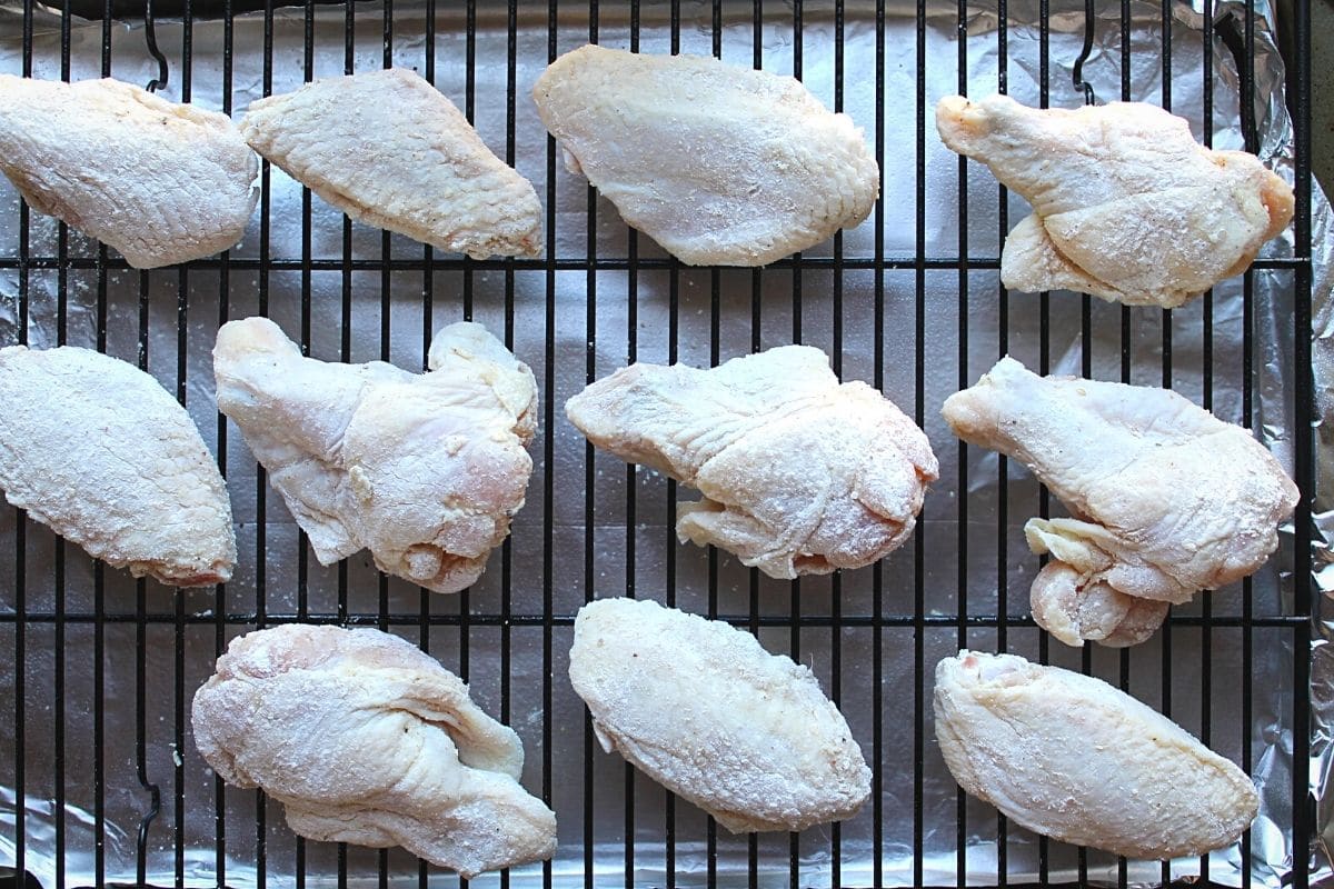 raw wings on rack on baking sheet