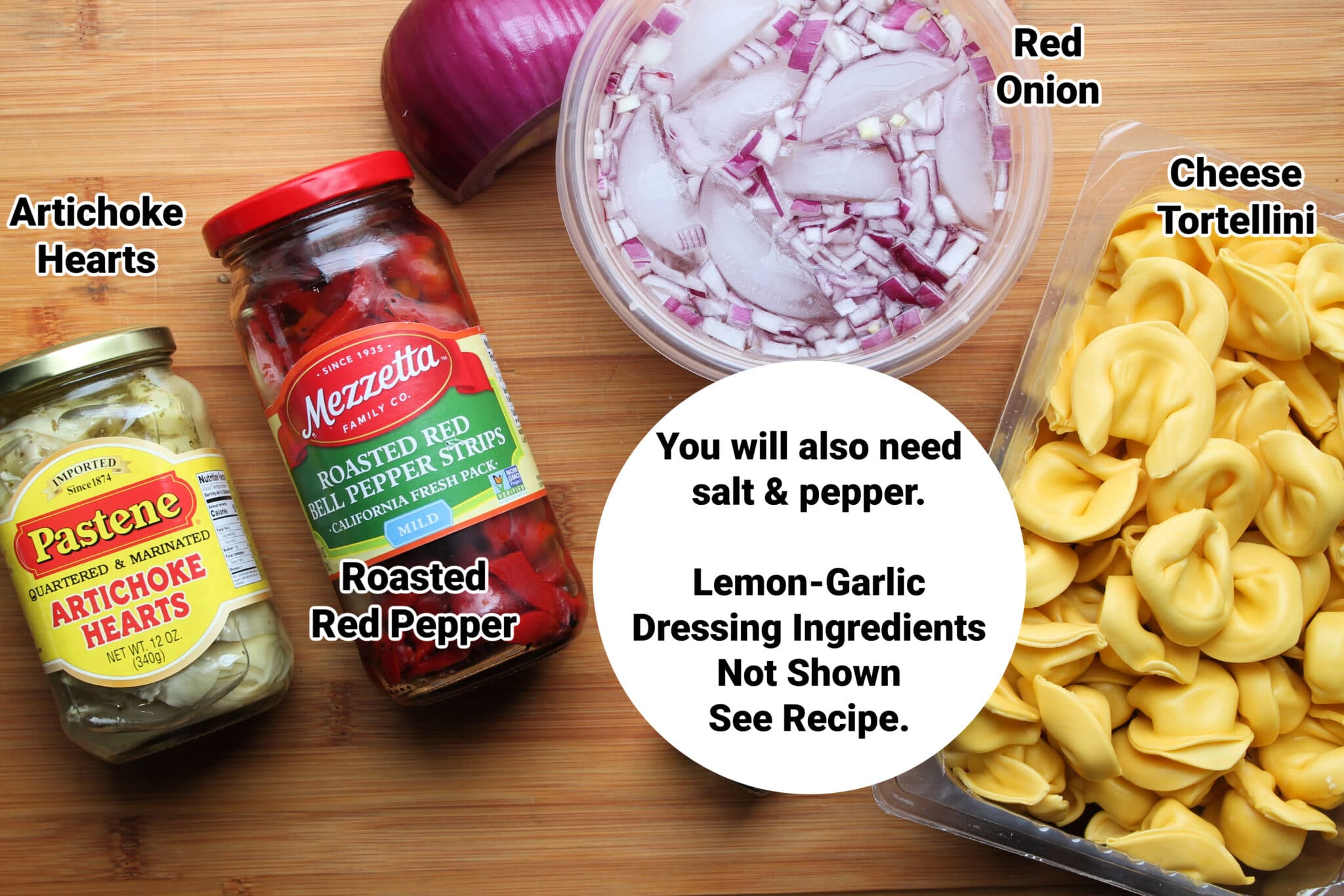 ingredients for tortellini pasta salad on wood cutting board