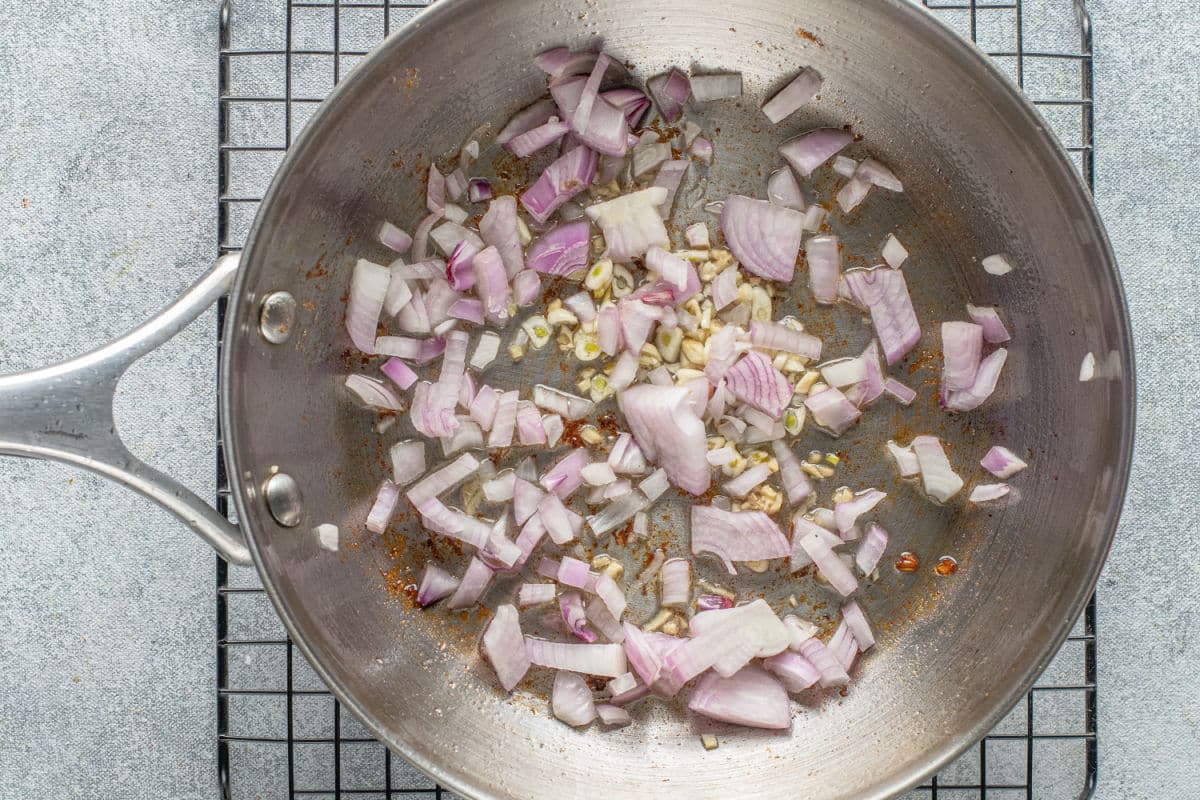 fry pan with cooking onion, garlic and ginger