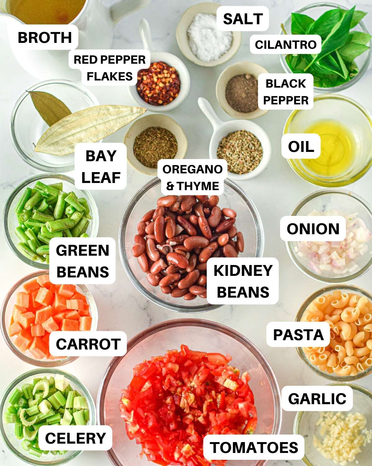 All soup ingredients in glass prep bowls with text overlay naming each ingredient.
