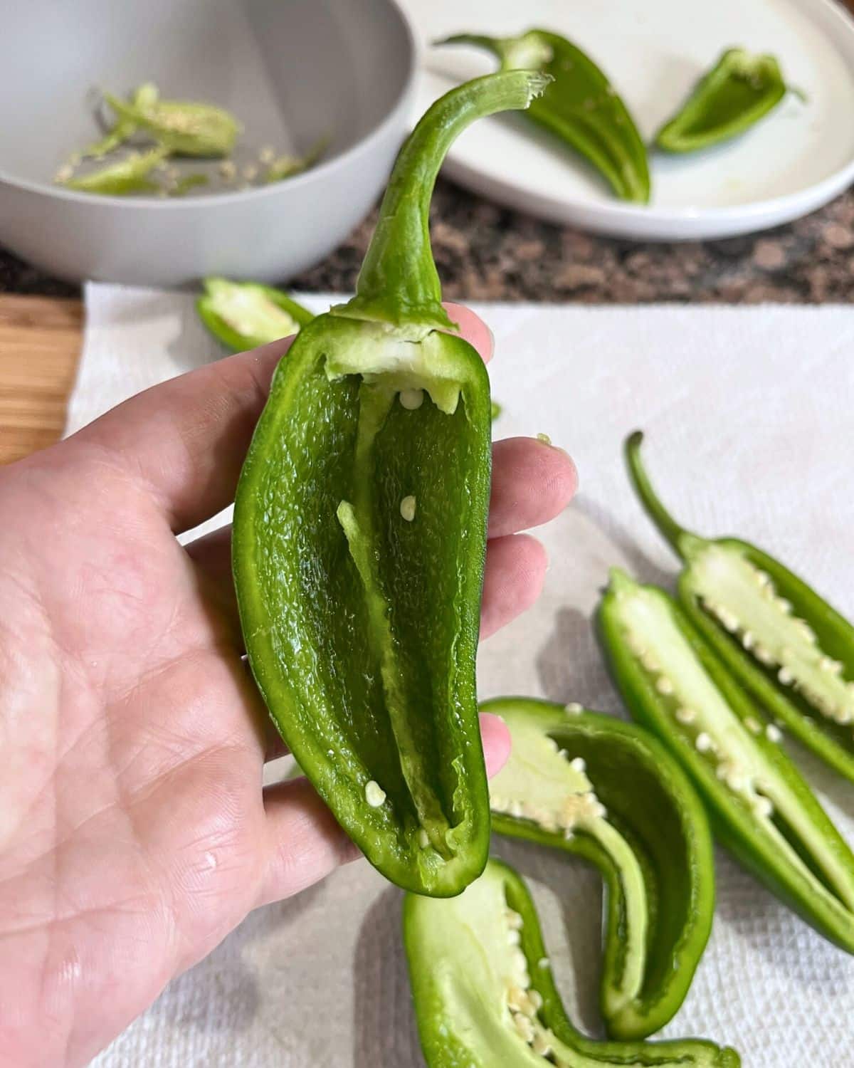 A jalapeno pepper that has been sliced down the middle, lengthwise.