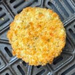 crispy coated boursin in the center of an air fryer basket.