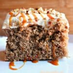caramel carrot poke cake close up of slice of cake.