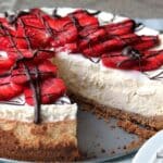 chocolate covered strawberry cheesecake with a slice removed.