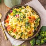 Prepared pasta salad in a brown serving bowl.