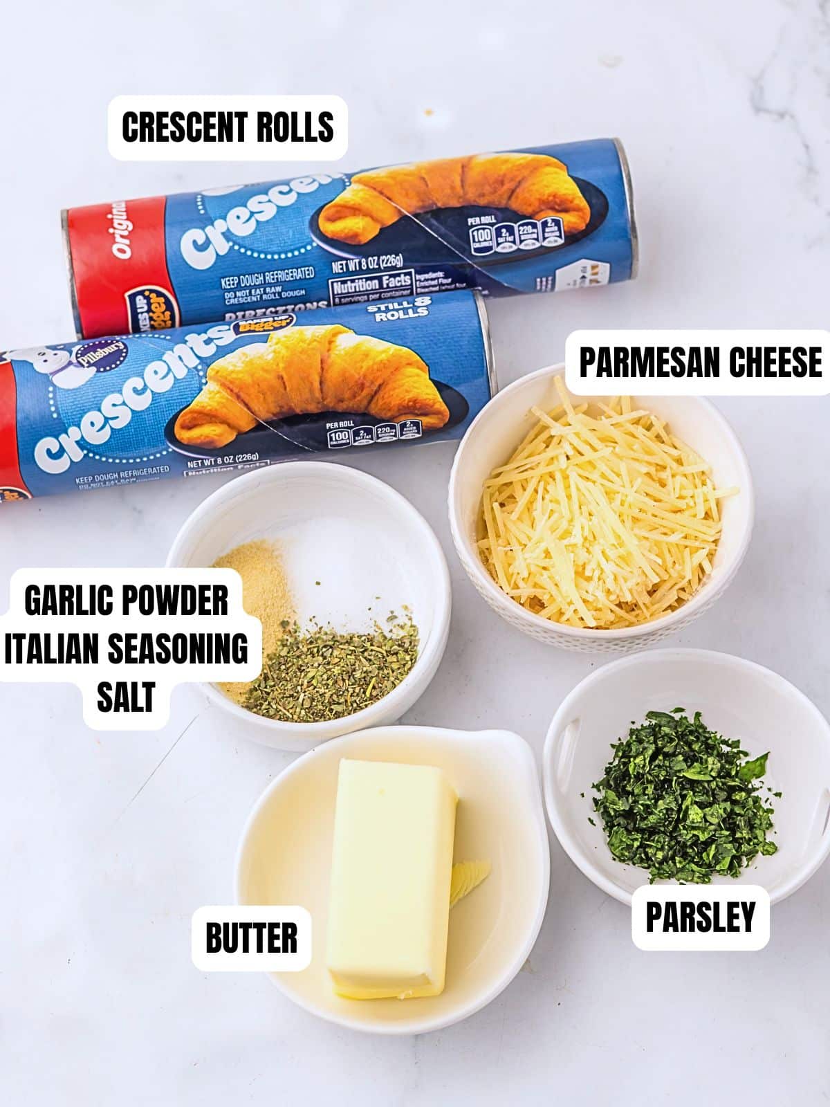 Two tubes of dough and 4 prep bowls full off the ingredients.