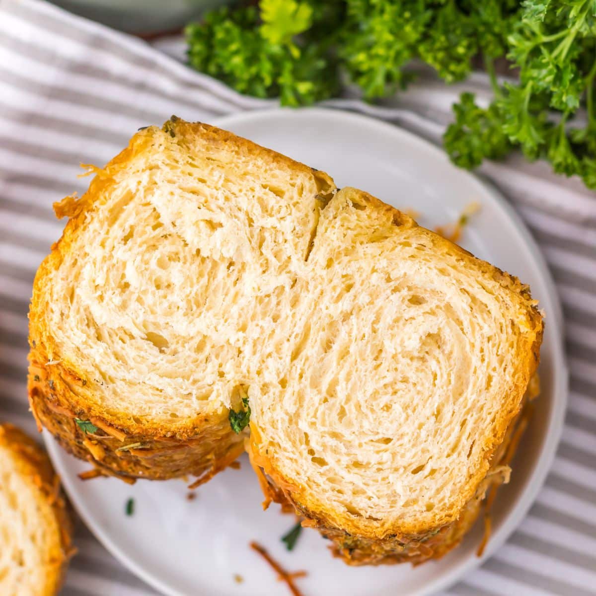 Top view of a slice of the prepared bread on a white plate.